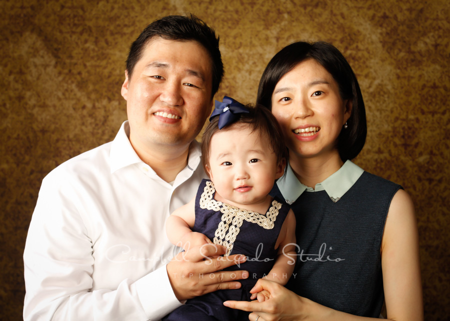  Portrait of family on amber light background by family photographers at Campbell Salgado Studio in Portland, Oregon. 