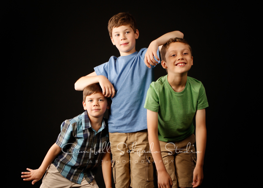  Portrait of boys on black background by family photographers at Campbell Salgado Studio in Portland, Oregon. 