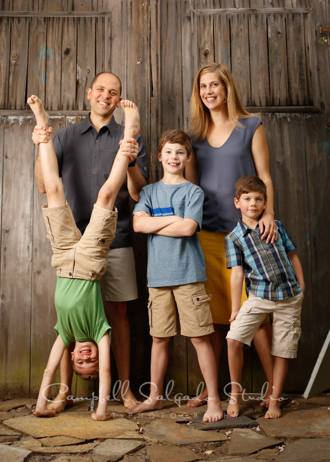 Portrait of family on brand doors background by family photographers at Campbell Salgado Studio in Portland, Oregon.