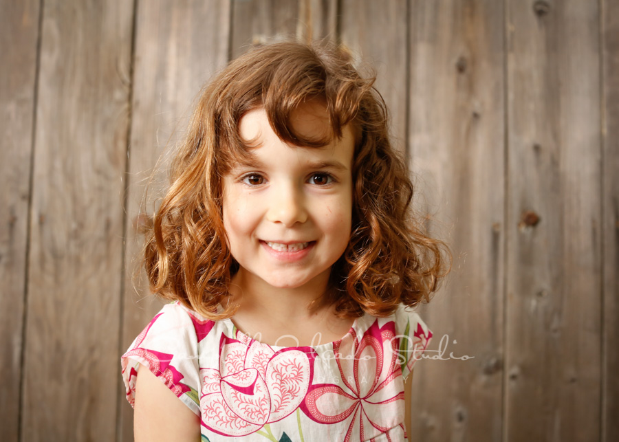 Portrait of girl on barn doors background by child photographers at Campbell Salgado Studio in Portland, Oregon. 