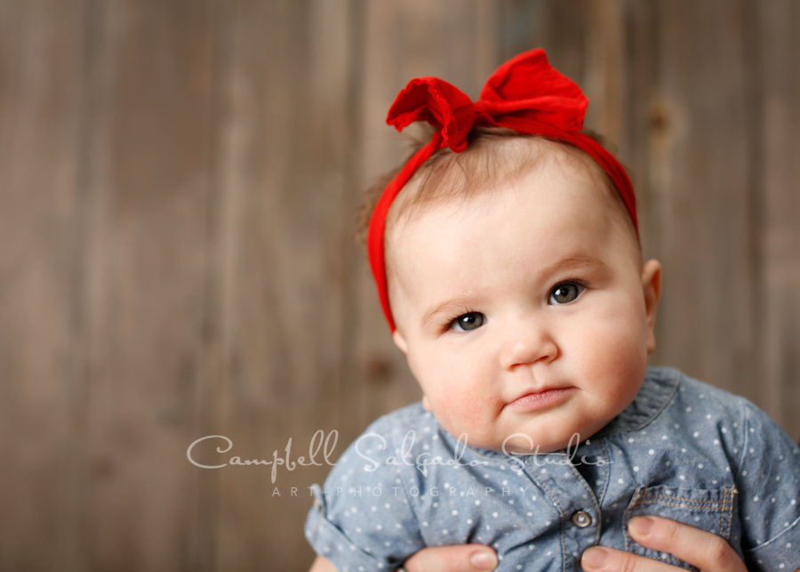  Portrait of baby on barn doors background by child photographers at Campbell Salgado Studio in Portland, Oregon. 