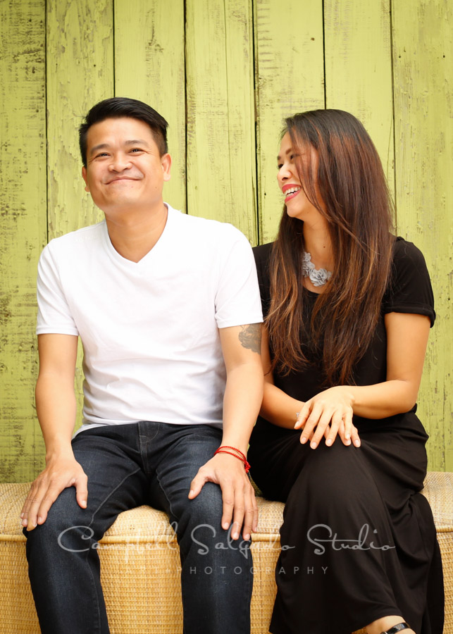  Portrait of brother and sister on lime fenceboards background by family photographers at Campbell Salgado Studio in Portland, Oregon. 