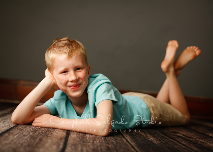  Portrait of boy on grey background by child photographers at Campbell Salgado Studio in Portland, Oregon. 
