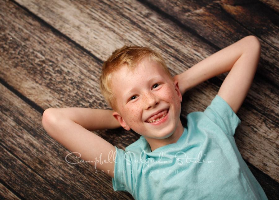  Portrait of boy on grey background by child photographers at Campbell Salgado Studio in Portland, Oregon. 