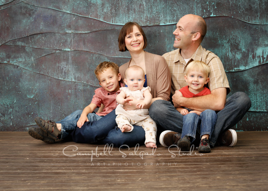  Portrait of family on copper wave background by family photographers at Campbell Salgado Studio in Portland, Oregon. 