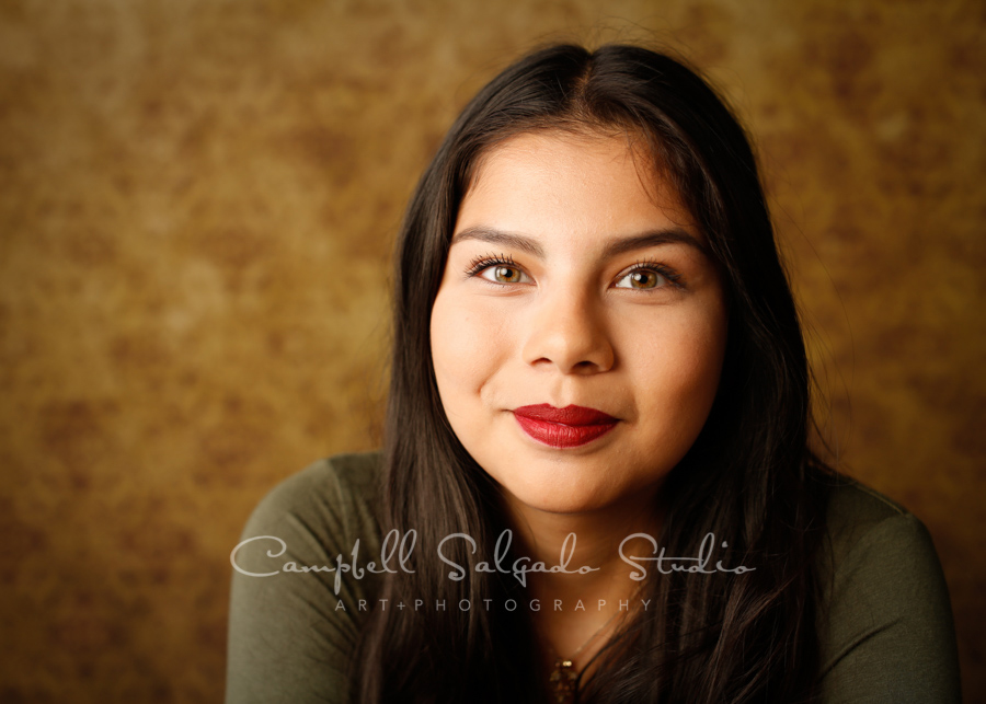  Portrait of teen on amber light background by teen photographers at Campbell Salgado Studio in Portland, Oregon. 