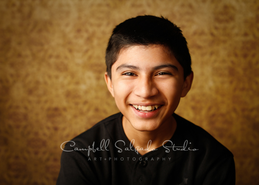  Portrait of teen on amber light background by teen photographers at Campbell Salgado Studio in Portland, Oregon. 