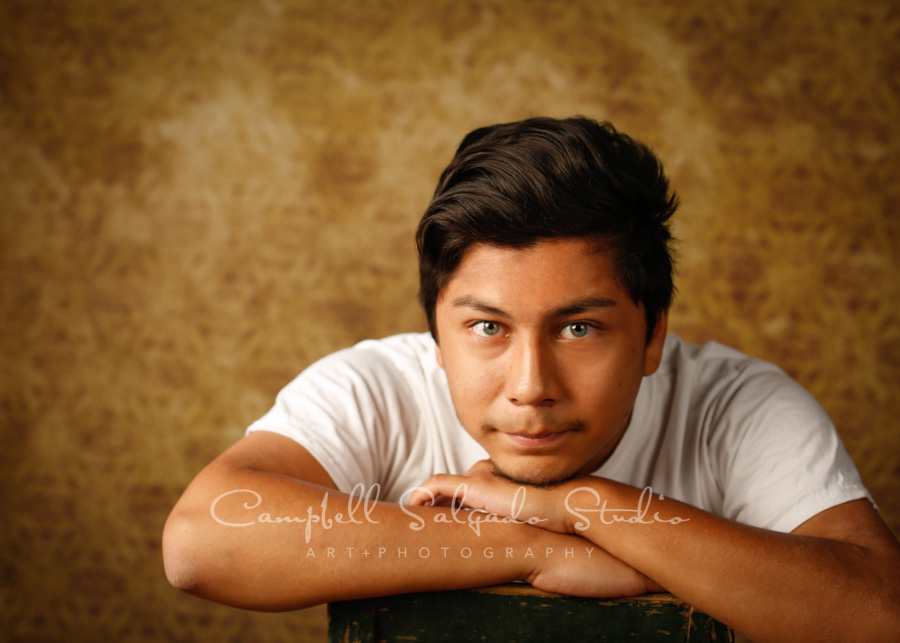  Portrait of teen on amber light background by teen photographers at Campbell Salgado Studio in Portland, Oregon. 