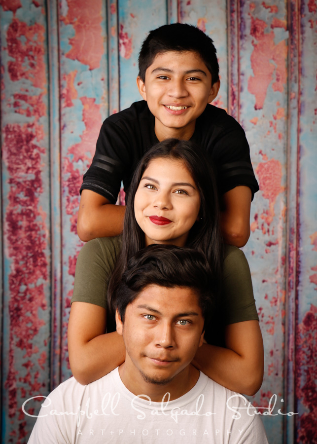 Portrait of teens on Italian rust background by teen photographers at Campbell Salgado Studio in Portland, Oregon.