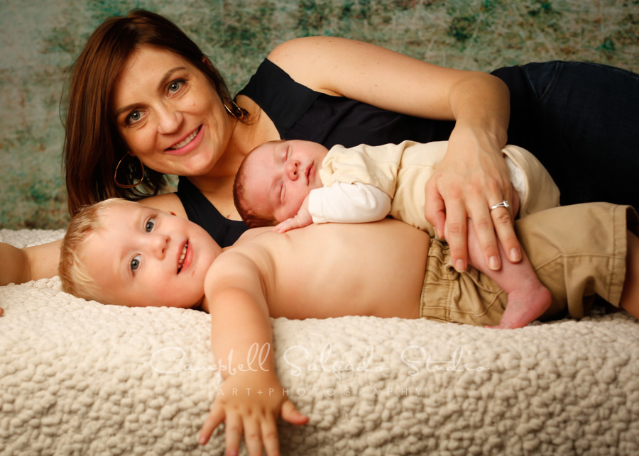  Portrait of family on weathered green background by family photographers at Campbell Salgado Studio in Portland, Oregon. 