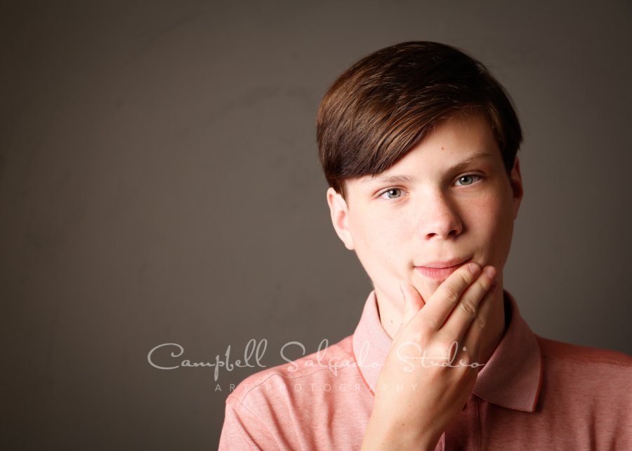  Portrait of teen on gray background by family photographers at Campbell Salgado Studio in Portland, Oregon. 