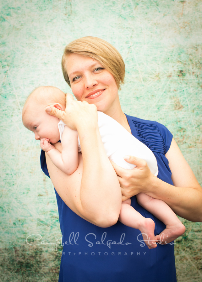  Portrait of mother and baby on weathered green background by family photographers at Campbell Salgado Studio in Portland, Oregon. 