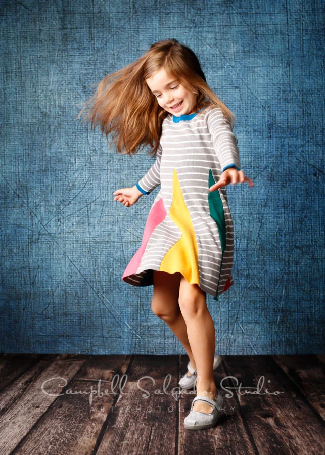 Portrait of girl on denim background by childrens photographers at Campbell Salgado Studio in Portland, Oregon.