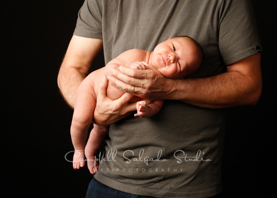  Portrait of baby on black background by newborn photographers at Campbell Salgado Studio in Portland, Oregon. 