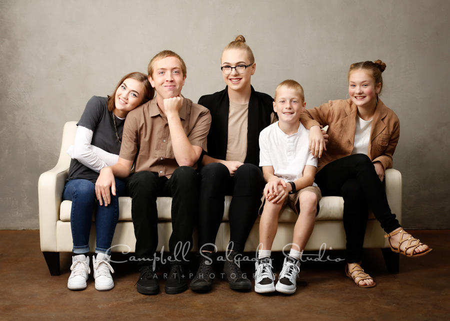  Portrait of siblings on modern grey background by family photographers at Campbell Salgado Studio in Portland, Oregon. 