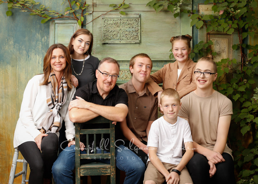  Portrait of family on vintage green doors background by family photographers at Campbell Salgado Studio in Portland, Oregon. 