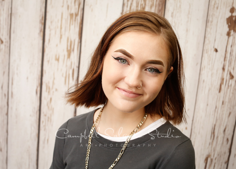  Portrait of teen on white fenceboards background by teen photographers at Campbell Salgado Studio in Portland, Oregon. 