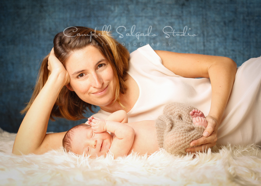  Portrait of mother and baby on denim background by newborn photographers at Campbell Salgado Studio in Portland, Oregon. 