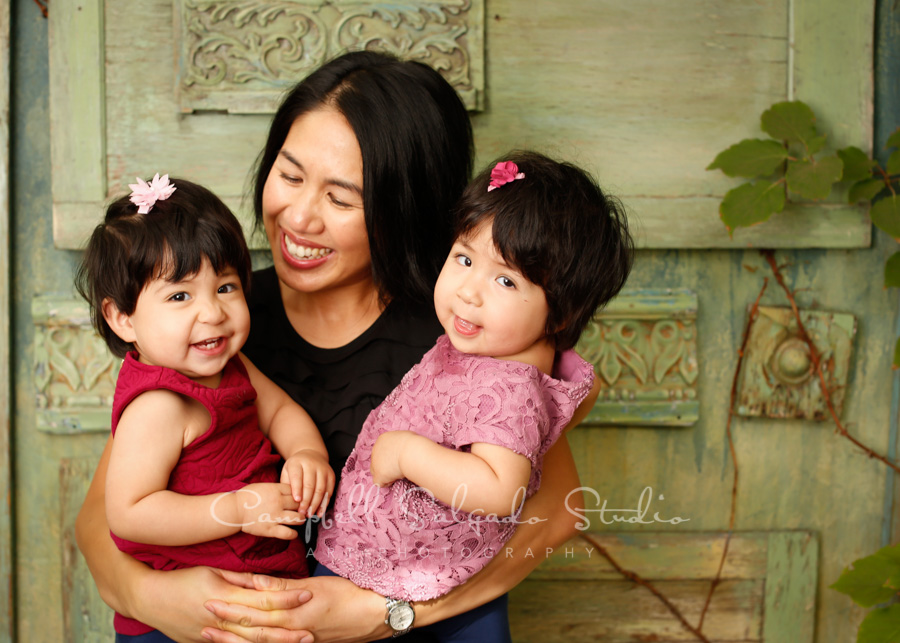  Portrait of mother and girls on vintage green doors background by family photographers at Campbell Salgado Studio in Portland, Oregon. 