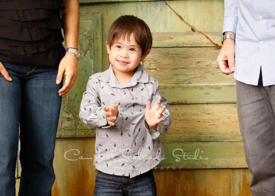  Portrait of boy on vintage green doors background by family photographers at Campbell Salgado Studio in Portland, Oregon. 