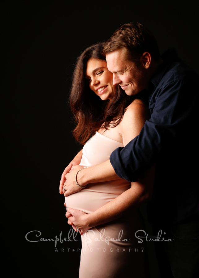  Maternity portrait of couple on black background by maternity photographers at Campbell Salgado Studio in Portland, Oregon. 