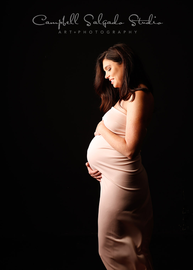  Maternity portrait of woman on black background by maternity photographers at Campbell Salgado Studio in Portland, Oregon. 