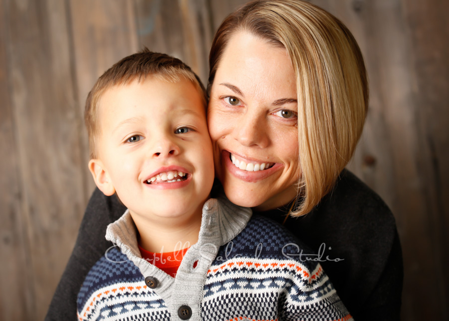  Portrait of family on barn door background by family photographers at Campbell Salgado Studio in Portland, Oregon. 