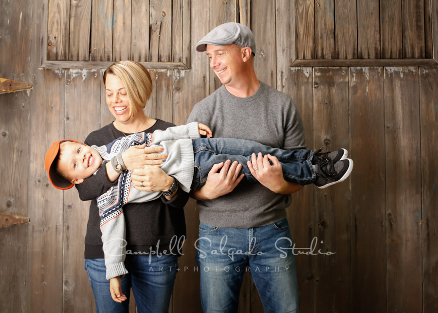  Portrait of family on barn door background by family photographers at Campbell Salgado Studio in Portland, Oregon. 