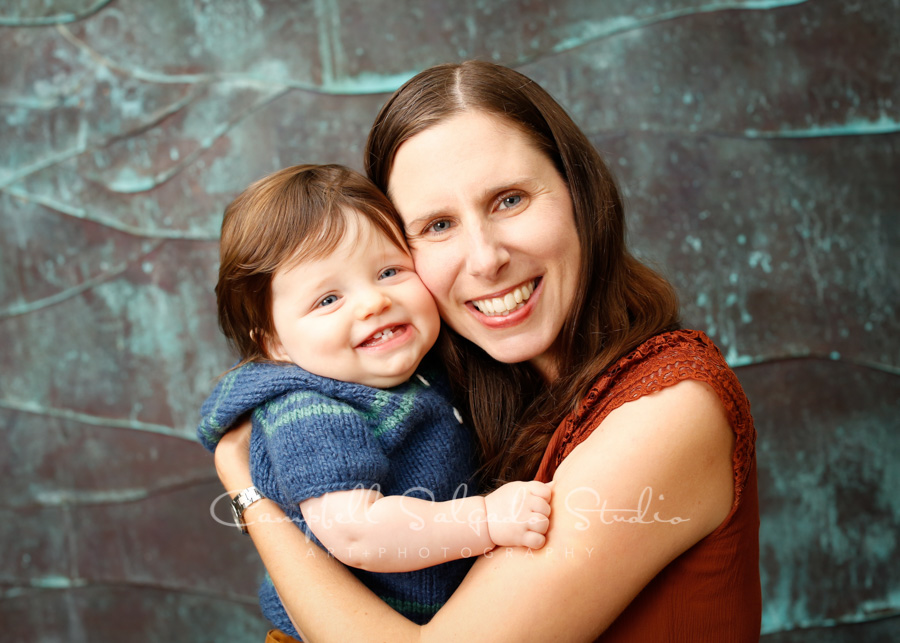  Portrait of mother and child on ocean wave background by family photographers at Campbell Salgado Studio in Portland, Oregon. 