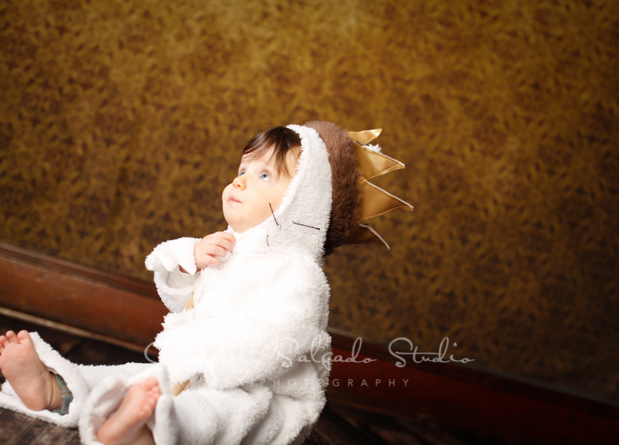  Portrait of child on amber light background by child photographers at Campbell Salgado Studio in Portland, Oregon. 