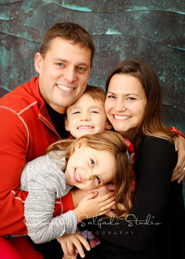  Portrait of family on ocean wave background by family photographers at Campbell Salgado Studio in Portland, Oregon. 