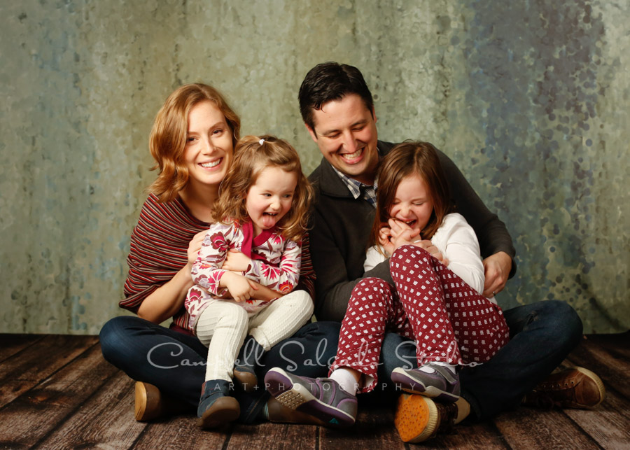  Portrait of family on rain dance background by family photographers at Campbell Salgado Studio in Portland, Oregon. 