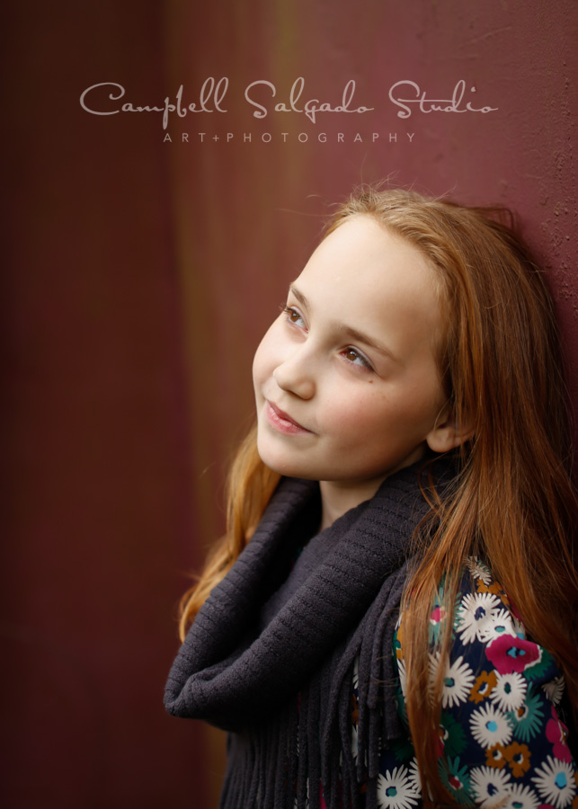  Portrait of girl on plum stucco background by child photographers at Campbell Salgado Studio in Portland, Oregon. 