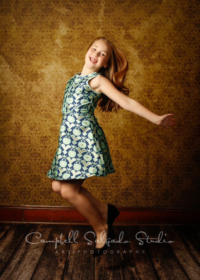  Portrait of girl on plum amber light background by child photographers at Campbell Salgado Studio in Portland, Oregon. 