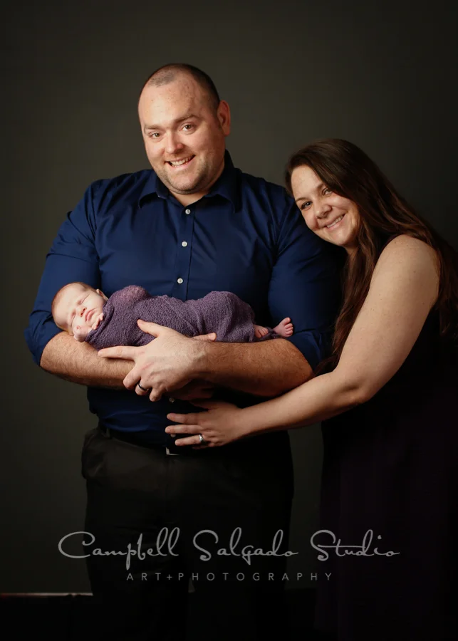 Portrait of family on grey background by newborn photographers at Campbell Salgado Studio in Portland, Oregon.
