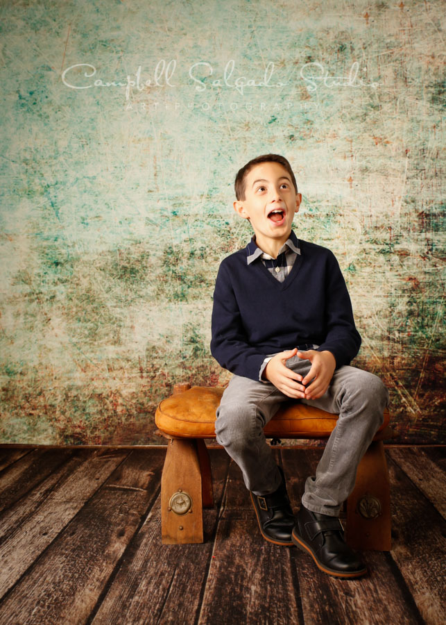  Portrait of boy on weathered green background by family photographers at Campbell Salgado Studio in Portland, Oregon. 