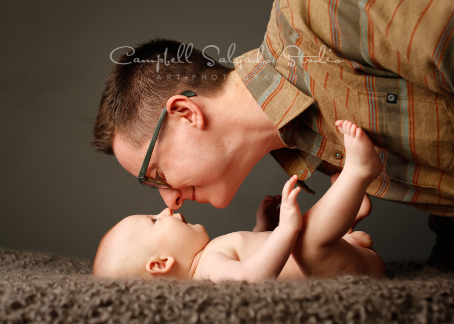  Portrait of father and son on gray background by family photographers at Campbell Salgado Studio in Portland, Oregon. 