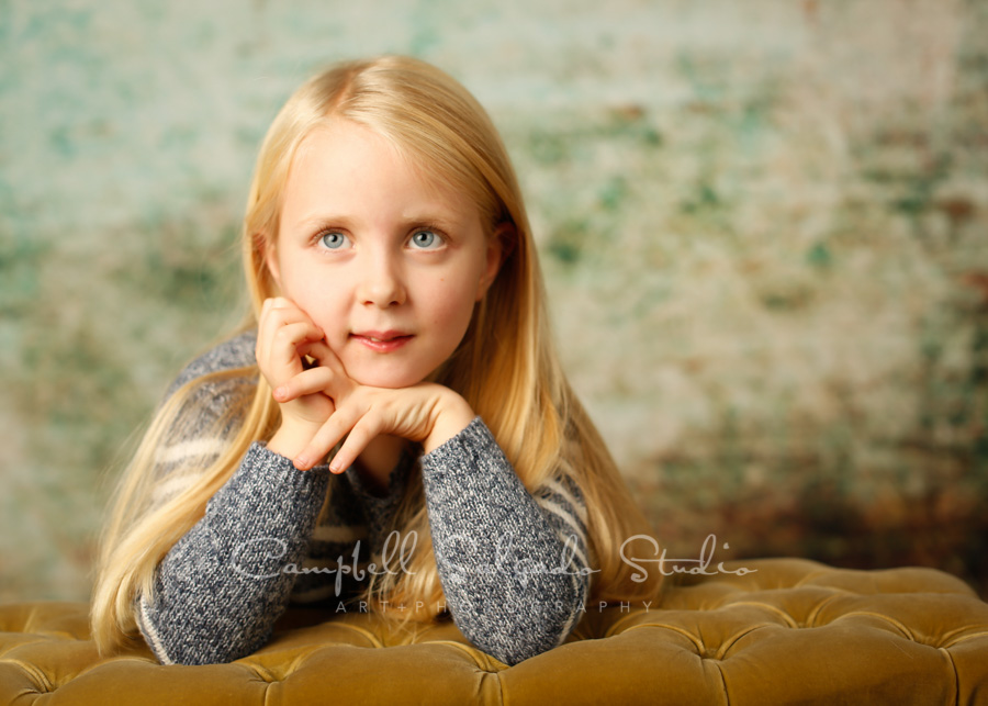  Portrait of girl on weathered green background by children's photographers at Campbell Salgado Studio in Portland, Oregon. 