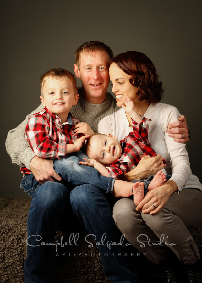  Portrait of family on gray background by family photographers at Campbell Salgado Studio in Portland, Oregon. 