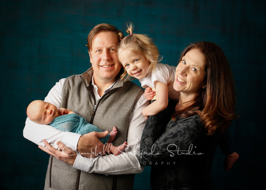 Portrait of family on deep ocean background by family photographers at Campbell Salgado Studio in Portland, Oregon. 