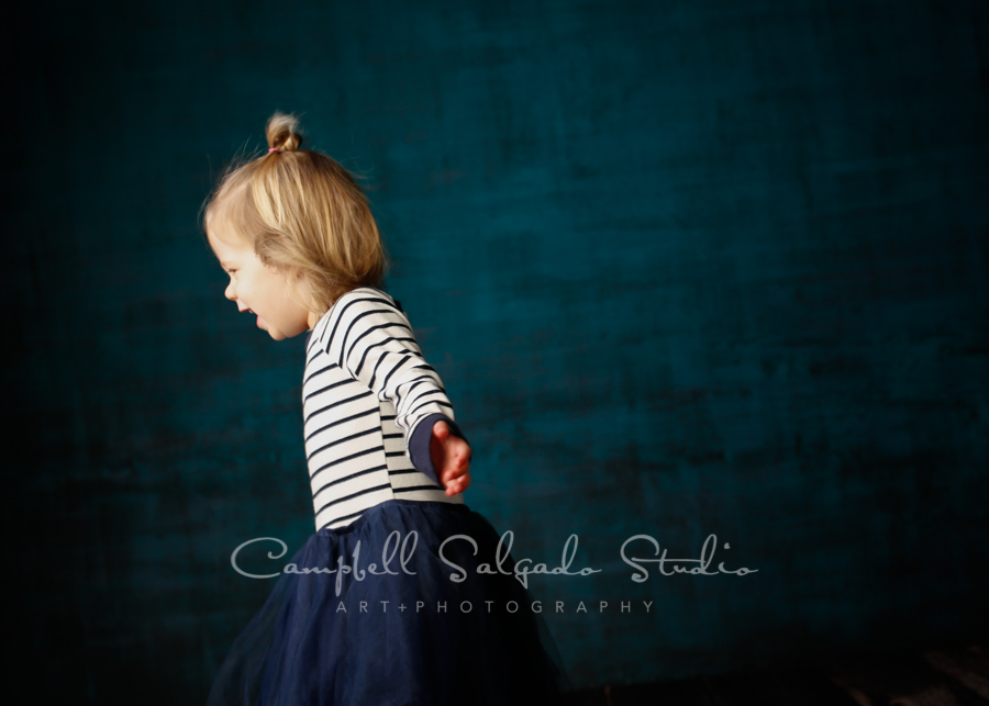  Portrait of girl on deep ocean background by child photographers at Campbell Salgado Studio in Portland, Oregon. 