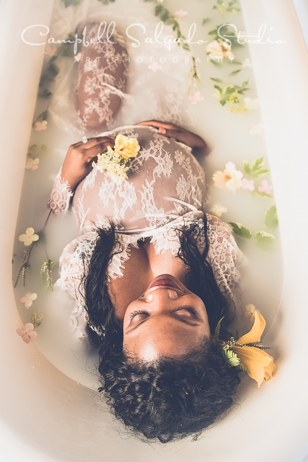  Milk bath pregnancy photography of a woman with yellow flowers and white lace by photographer Kim Campbell at Campbell Salgado Studio in Portland, Oregon. 