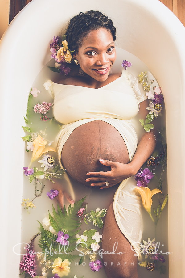  Milk bath photography of a pregnant woman with yellow and purple flowers at Campbell Salgado Studio in Portland, Oregon. Unique idea for pregnancy or maternity photography. 