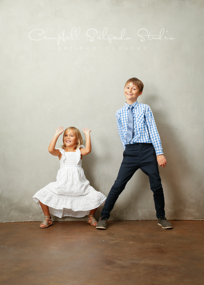  Portrait of kids on modern grey background by childrens photographers at Campbell Salgado Studio in Portland, Oregon. 