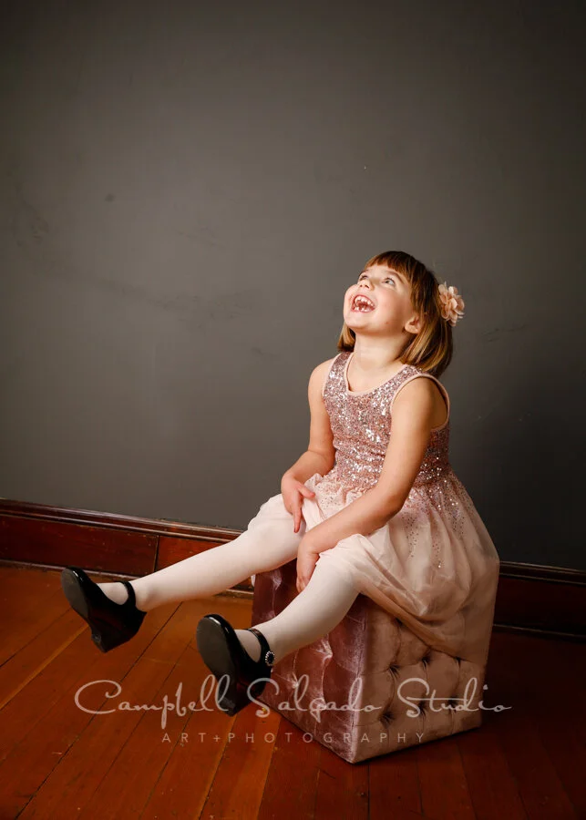 Portrait of girl on grey background by child photographers at Campbell Salgado Studio in Portland, Oregon.