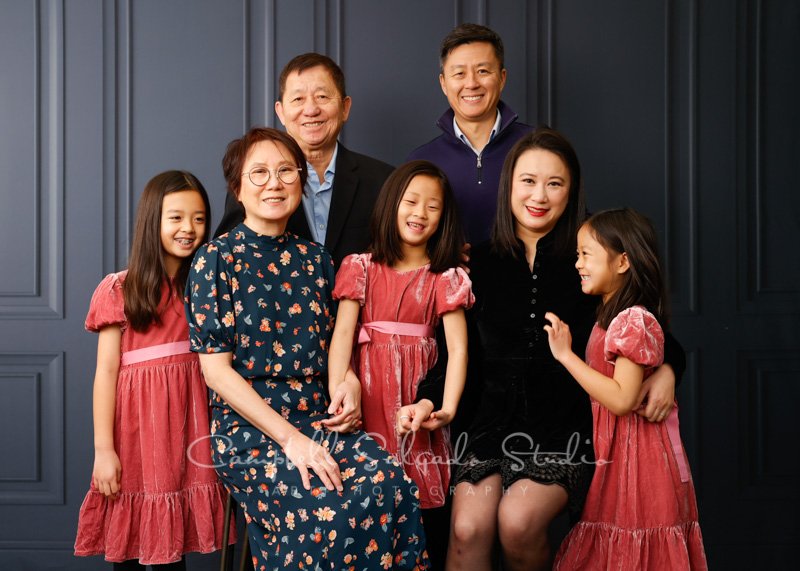  Portrait of multi-generational family on Portland Parlour background by family photographers at Campbell Salgado Studio in Portland, Oregon. 