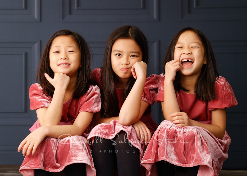  Portrait of sisters on Portland Parlour background by children’s photographers at Campbell Salgado Studio in Portland, Oregon. 