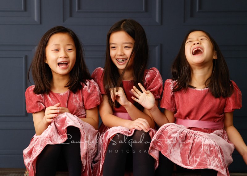  Portrait of sisters on Portland Parlour background by children’s photographers at Campbell Salgado Studio in Portland, Oregon. 