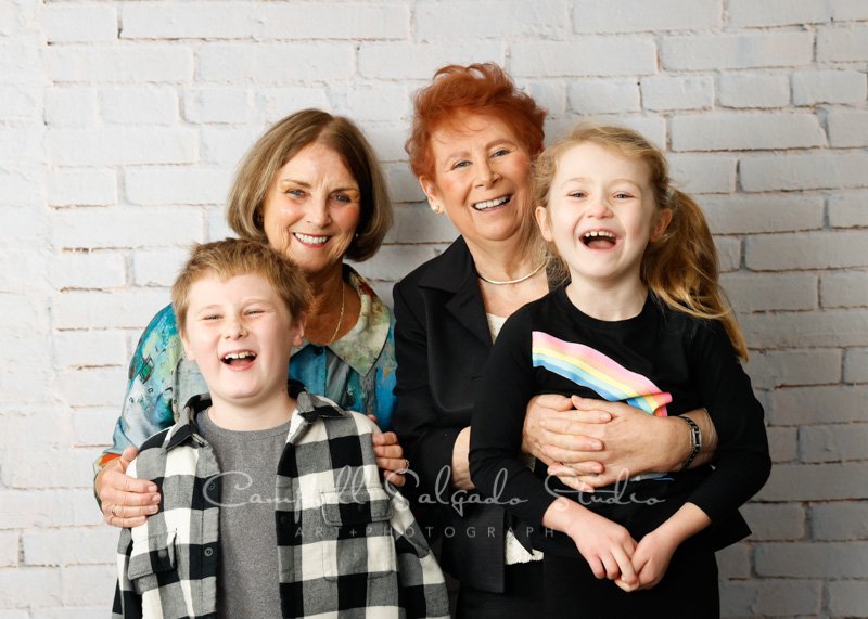  Portrait of multi-generational family on ivory brick background by family photographers at Campbell Salgado Studio in Portland, Oregon. 