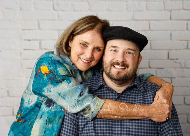  Portrait of mother and son on ivory brick background by family photographers at Campbell Salgado Studio in Portland, Oregon. 